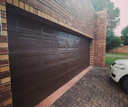 Black Aluzinc double sectional garage doors installed by Door Legend