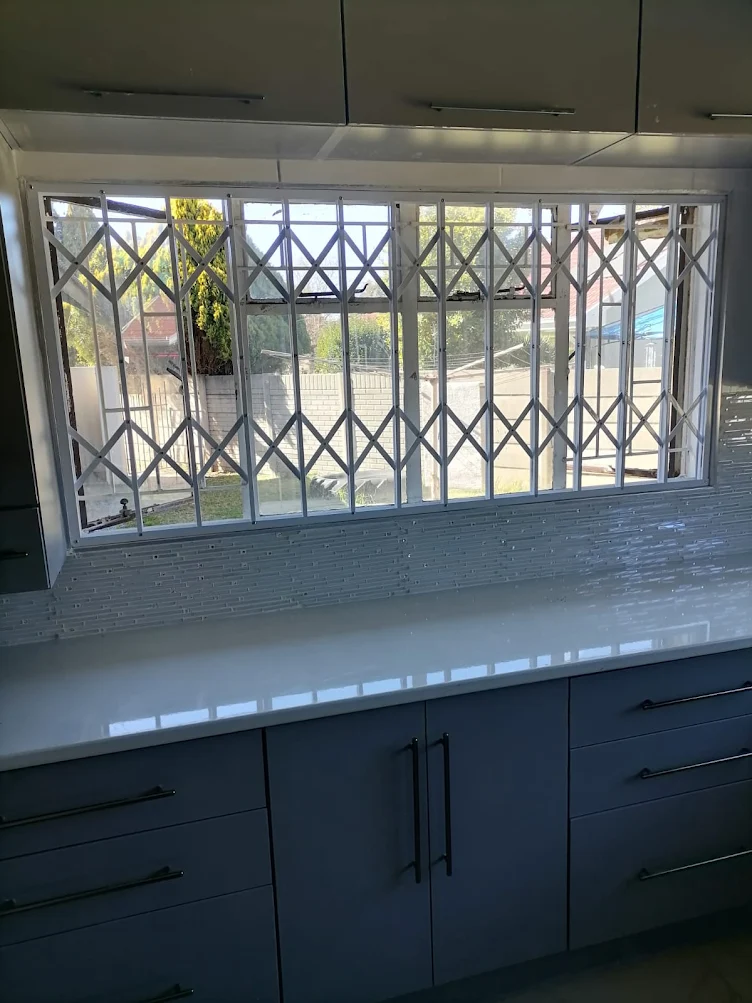 Black roller shutter door installed on brick building opening
